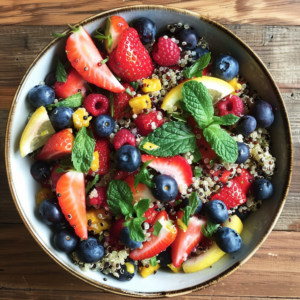 Feast your eyes on our vibrant Summer Berry & Quinoa Salad, a bowl bursting with goodness! This delightful mix features succulent strawberries, juicy blueberries, tangy raspberries, and sweet mango chunks. Fresh mint leaves add an invigorating touch while zesty lemon wedges enhance the flavors. Arranged to perfection on a rustic wooden table, this health-packed salad is as beautiful as it is nutritious. At Zestful Blends, we prioritize freshness and eco-friendly practices in every product—from our tempting fruit salads and rejuvenating juices to wholesome snacks, energizing smoothies, whole fruit packs, and delectable desserts. Enjoy the ultimate blend of taste and wellness!