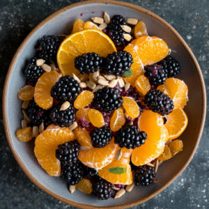 A vibrant bowl brimming with our signature Blackberry & Orange Zest fruit salad, complemented by juicy mandarins and a sprinkle of nourishing sunflower seeds. Positioned against a rich, textured backdrop, the radiant colors of our fresh fruits truly pop! Our fruit salads are bursting with goodness, providing a delightful blend of flavor and nutrition. Packed with vitamins and antioxidants, this refreshing treat is not only delicious but also eco-conscious for those who care about their health and the planet. Dive into a world where freshness meets vitality!