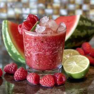 Experience the refreshing burst of goodness with our Crimson Cooler Smoothie! This vibrant delight, crowned with ice and garnished with a zesty slice of lime and three succulent raspberries, is packed with nourishing freshness. Surround yourself in the lively colors of fresh raspberries, juicy lime halves, and crisp watermelon slices—each ingredient adding a dash of natural vitality. At Zestful Blends, we’re committed to delivering healthful indulgence in every sip while embracing eco-friendly practices. Sip sustainably, savor wholeheartedly!