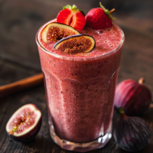 Indulge in the vibrant pink delight of our Fig and Berry Fusion Smoothie, bursting with goodness! This creamy, nutrient-packed blend is topped with luscious sliced figs and a halved strawberry, making every sip a taste of health and freshness. Set against a rich dark wooden surface, the scene is beautifully complemented by whole figs and berries that promise pure, natural flavors. Enjoy Zestful Blends' offerings – from fruit salads to juices, snacks to smoothies – each crafted to nourish your body and invigorate your senses while honoring our eco-friendly commitment.