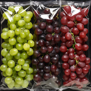 A close-up image showcases three vibrant clusters of grapes, each bursting with goodness in transparent, eco-friendly bags. From left to right, the clusters feature juicy green grapes, rich black grapes, and succulent red grapes. Neatly arranged side by side against a sleek black background, they exemplify Zestful Blends' commitment to freshness and health. This display not only highlights the natural beauty and variety of our premium fruit packs but also reflects our dedication to sustainable packaging solutions.