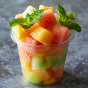 A crystal-clear cup brimming with our Melon Medley Magic—a tantalizing blend of watermelon, cantaloupe, and honeydew melon, crowned with vibrant mint leaves. Bursting with goodness, this refreshing medley embodies the essence of freshness and health benefits in every bite. Crafted to invigorate your senses and nourish your body, it's a splendid choice whether you're on the go or savoring a moment of delight. Our eco-friendly packaging ensures you can relish this nutritious treat while being kind to the planet. Join Zestful Blends and experience the true taste of vitality!