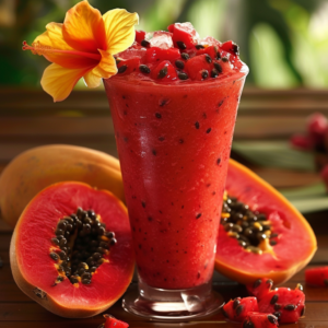 Experience the zestful vitality of our Tropical Hibiscus Smoothie, bursting with goodness! This vibrant smoothie, adorned with a cheerful yellow hibiscus flower and luscious chunks of ripe papaya, sits elegantly in a tall glass. Surrounding the smoothie are fresh, halved papayas showcasing their nutrient-rich black seeds. The tropical backdrop features lush green foliage, creating an inviting ambiance that highlights the freshness and health benefits of our products. Indulge in our eco-friendly delights—fruit salads, juices, snacks, smoothies, whole fruit packs, and desserts—that harmoniously blend nature’s finest ingredients for your well-being.